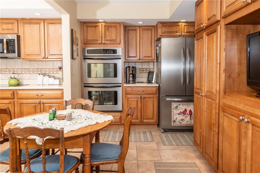 495 North Ben Franklin Road Indiana, PA 15701 - Photo 10 of 49 a kitchen with a refrigerator and a stove top oven