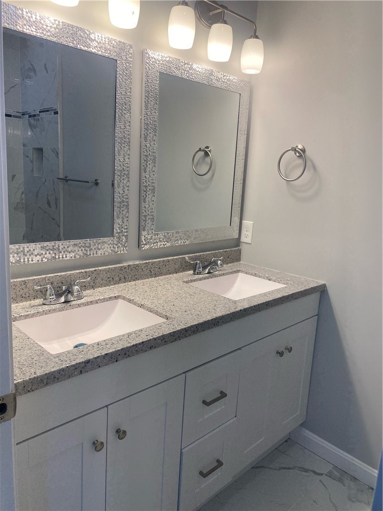 184 Avenue C, Unit M2 Woonsocket, RI 02895 - Photo 5 of 11 Primary bathroom featuring a double-sink vanity and a walk-in shower.