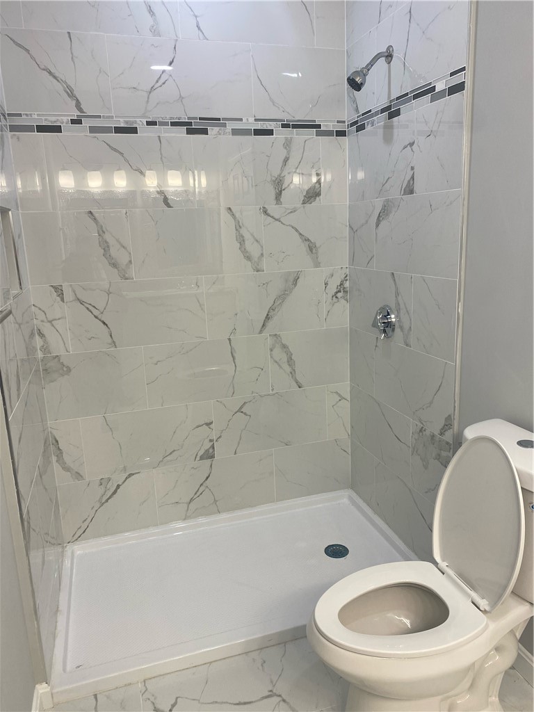 184 Avenue C, Unit M2 Woonsocket, RI 02895 - Photo 6 of 11 Primary bathroom featuring a double-sink vanity and a walk-in shower.