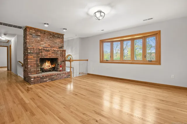 a view of a kitchen with a stove wooden floor and a kitchen