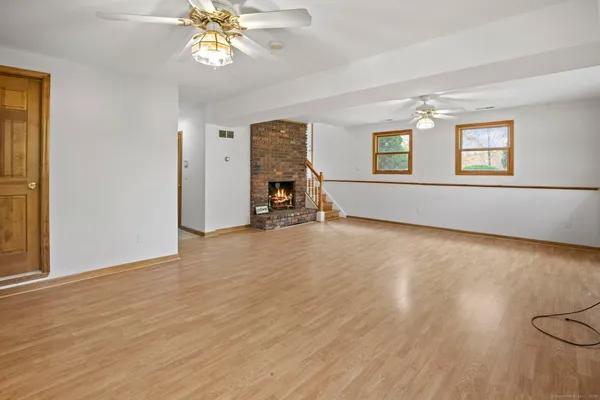 a view of a livingroom with a window and wooden floor