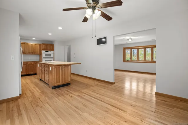 wooden floor fireplace and windows in an empty room