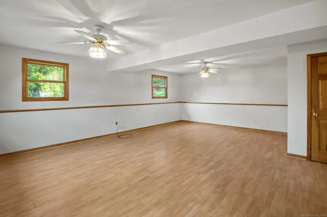 a view of a livingroom with a window and wooden floor
