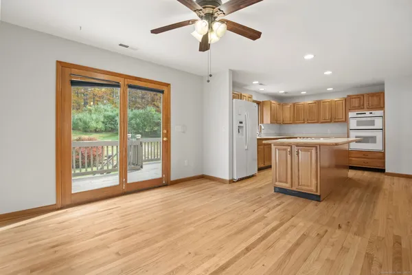 a view of a kitchen with a stove wooden floor and a kitchen