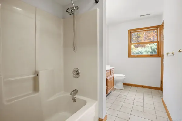 a bathroom with a bathtub and toilet