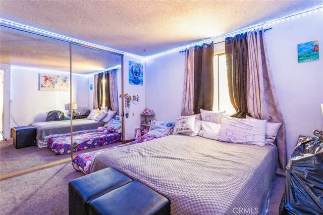 a bedroom with a bed and a mirror