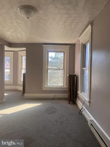 a view of a hallway with wooden shelves