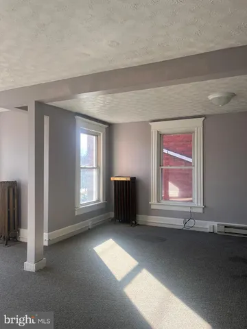 an empty room with a empty space and windows