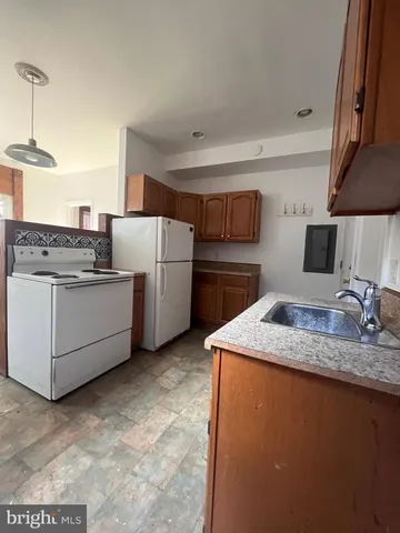 a view of an empty room with closet and wooden floor