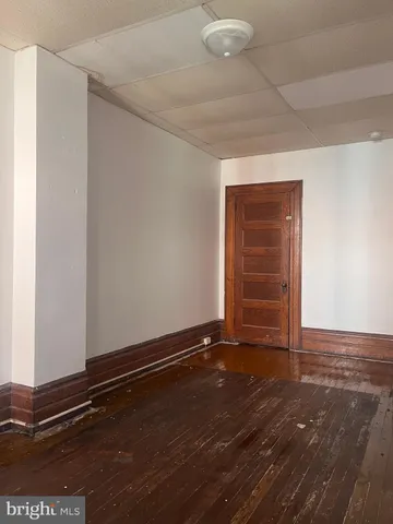 an empty room with windows and entrance
