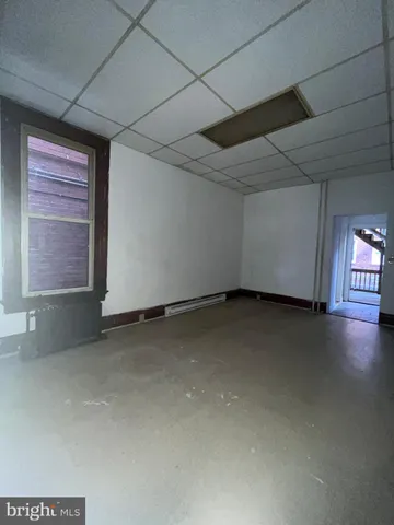 a bathroom with a sink toilet and window