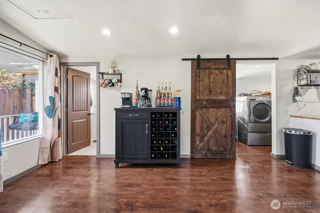 a view of a kitchen with refrigerator and windows