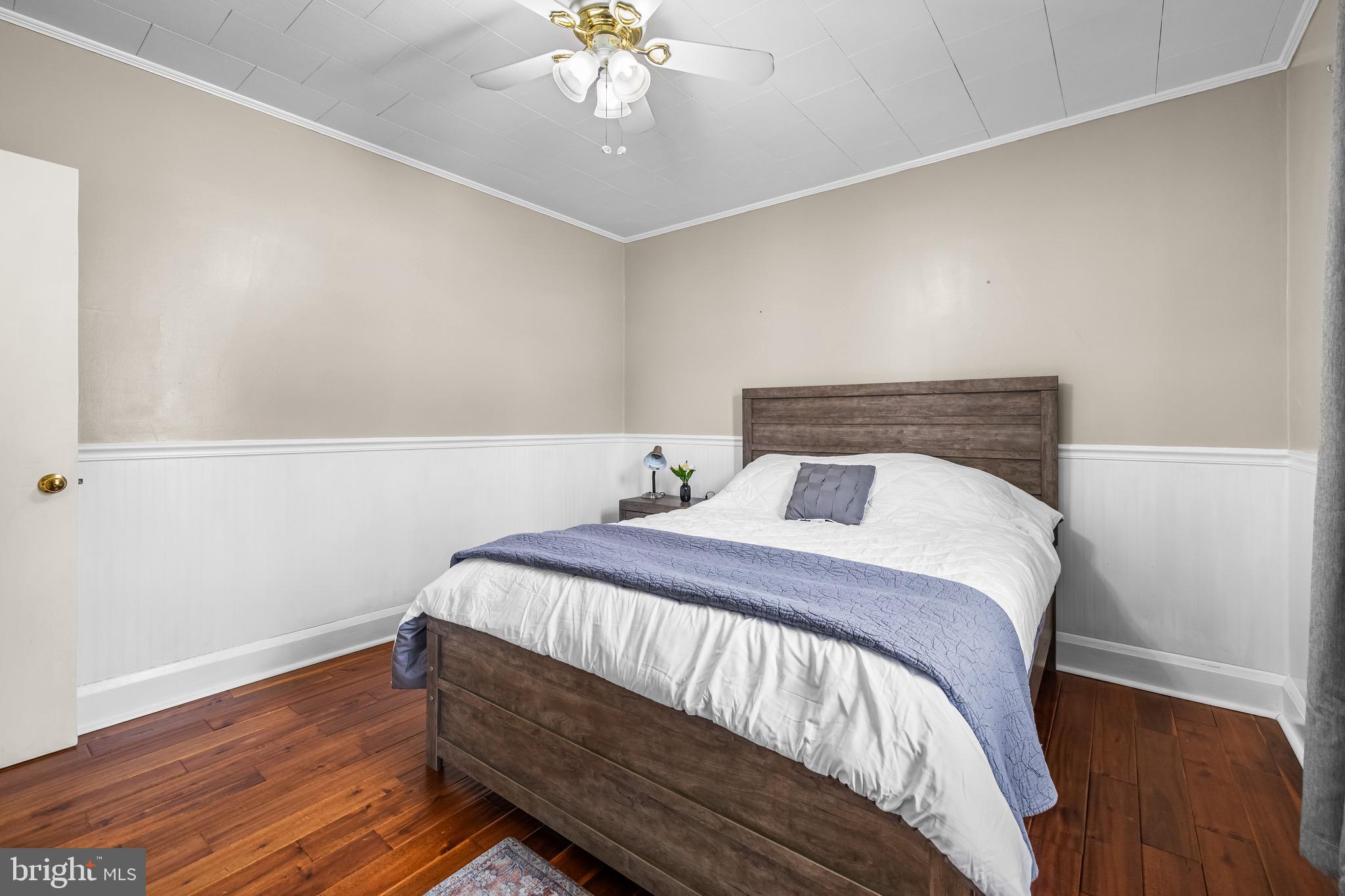 2913 Ritchie Avenue Baltimore, MD 21219 - Photo 18 of 34 a bedroom with a bed and wooden floor