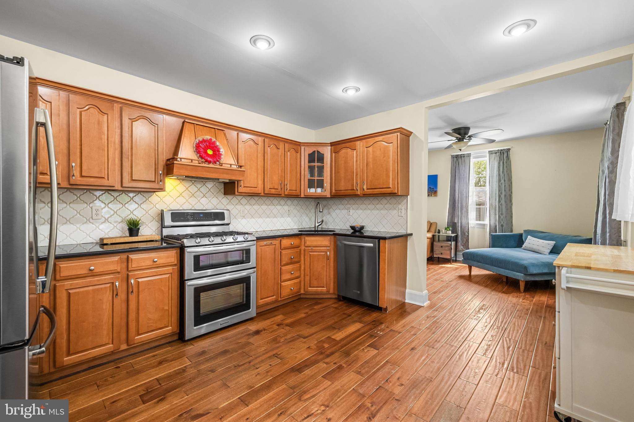 2913 Ritchie Avenue Baltimore, MD 21219 - Photo 8 of 34 a kitchen with stainless steel appliances granite countertop a stove and wooden cabinets