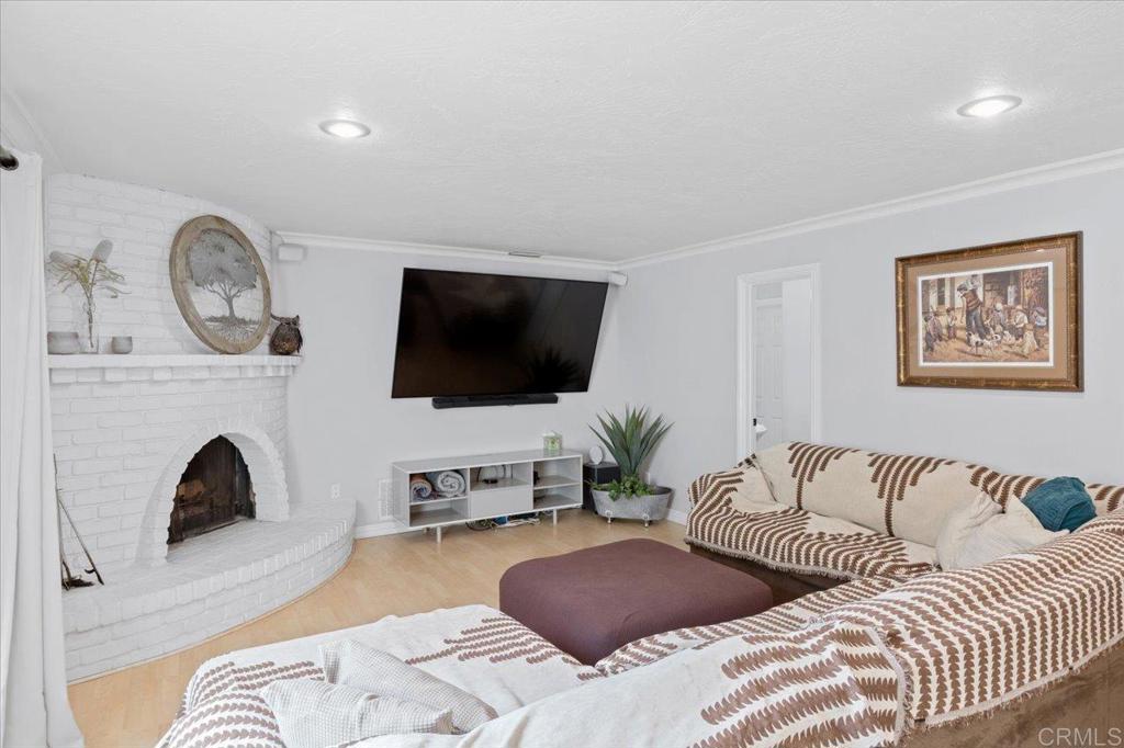 32460 Lilac Road Valley Center, CA 92082 - Photo 12 of 45 a bedroom with furniture a flat screen tv and a fireplace