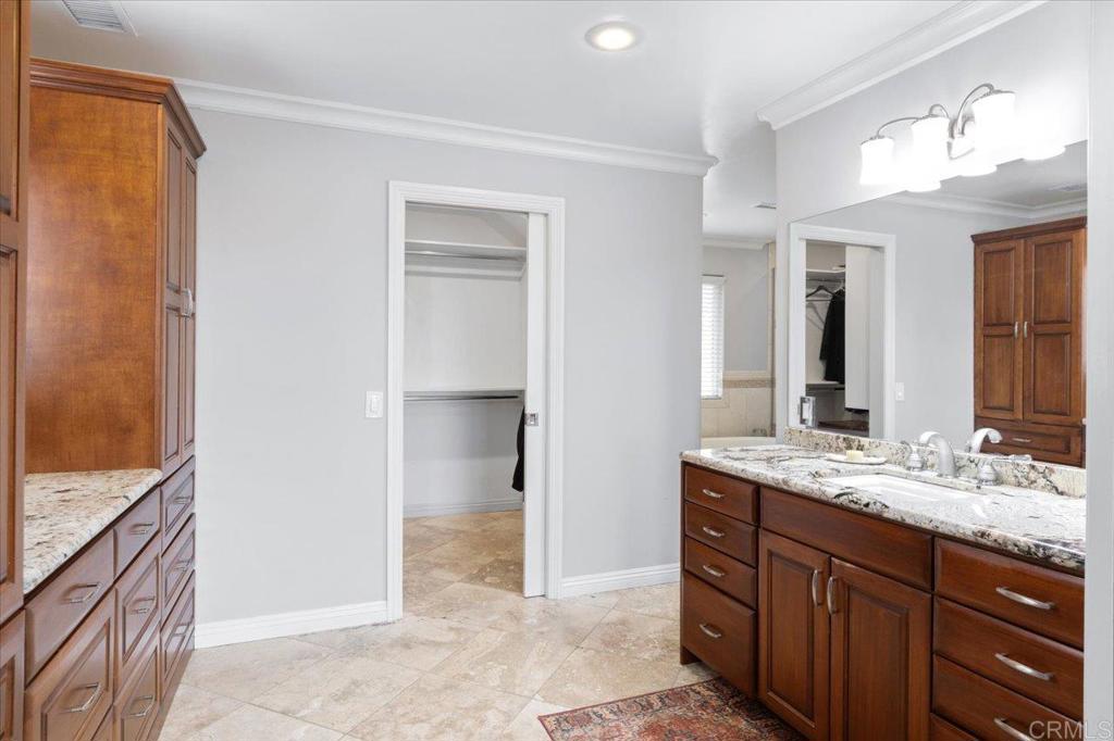 32460 Lilac Road Valley Center, CA 92082 - Photo 21 of 45 a bathroom with a granite countertop sink and a mirror