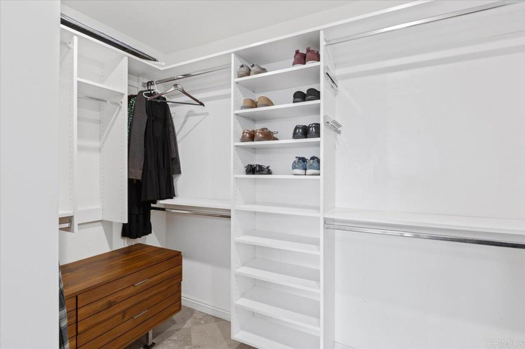32460 Lilac Road Valley Center, CA 92082 - Photo 23 of 45 a view of walk in closet with clothes and shoes