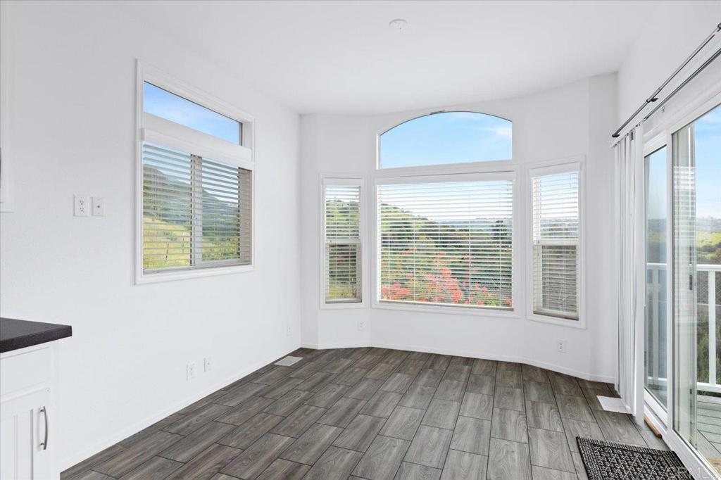32460 Lilac Road Valley Center, CA 92082 - Photo 32 of 45 an empty room with wooden floor and windows