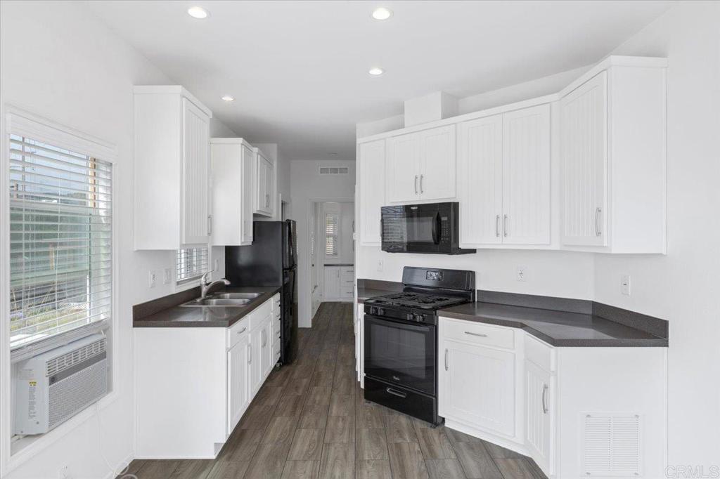32460 Lilac Road Valley Center, CA 92082 - Photo 33 of 45 a kitchen with granite countertop a sink a counter top space stainless steel appliances and cabinets