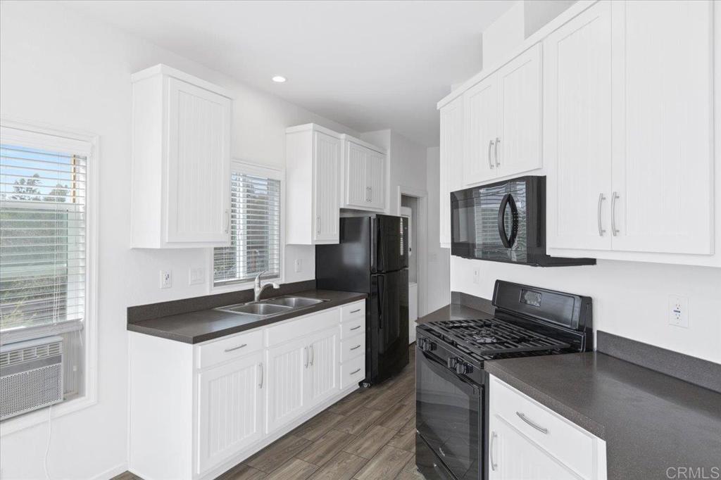 32460 Lilac Road Valley Center, CA 92082 - Photo 34 of 45 a kitchen with granite countertop a sink stove and refrigerator