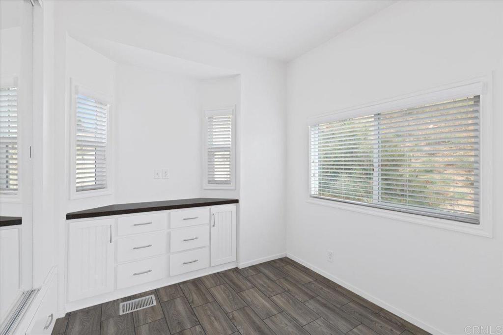 32460 Lilac Road Valley Center, CA 92082 - Photo 35 of 45 a view of an empty room with wooden floor and a window