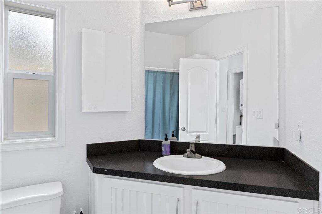 32460 Lilac Road Valley Center, CA 92082 - Photo 36 of 45 a bathroom with a granite countertop sink and a mirror