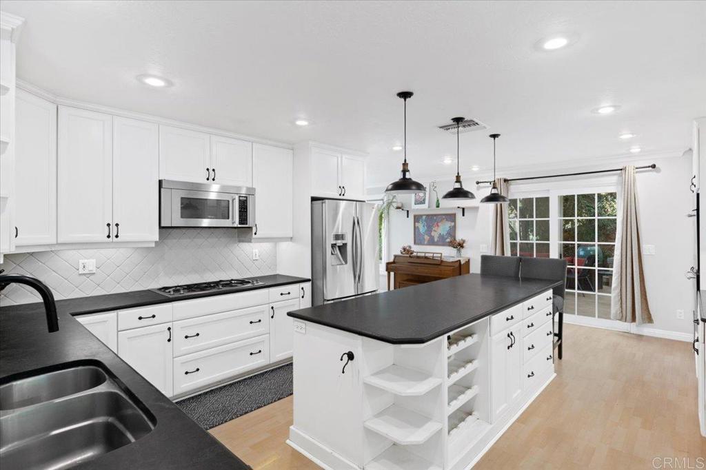 32460 Lilac Road Valley Center, CA 92082 - Photo 10 of 45 a kitchen with stainless steel appliances granite countertop a sink stove and refrigerator