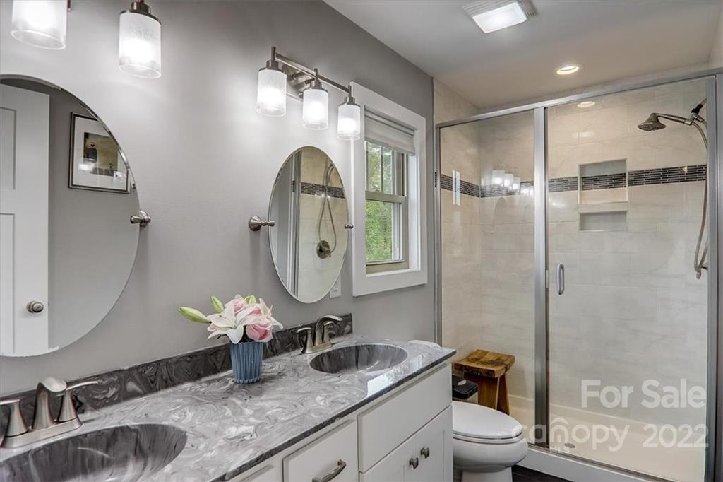 11 Ridge Brook Drive Weaverville, NC 28787 - Photo 17 of 38 a bathroom with a granite countertop sink mirror toilet and shower