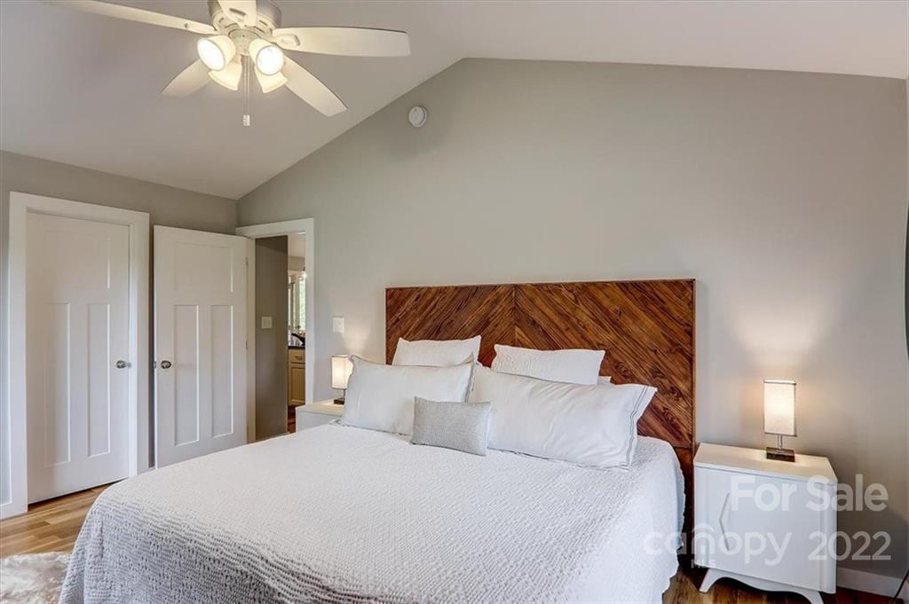 11 Ridge Brook Drive Weaverville, NC 28787 - Photo 18 of 38 a bedroom with a bed and a chandelier