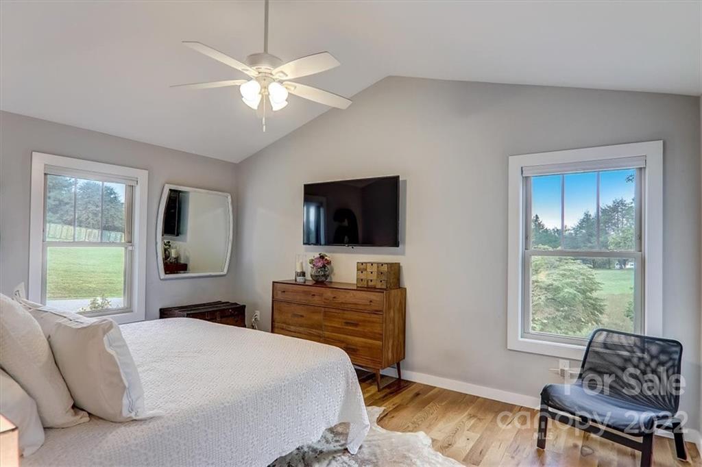 11 Ridge Brook Drive Weaverville, NC 28787 - Photo 19 of 38 a bedroom with a bed and a flat screen tv