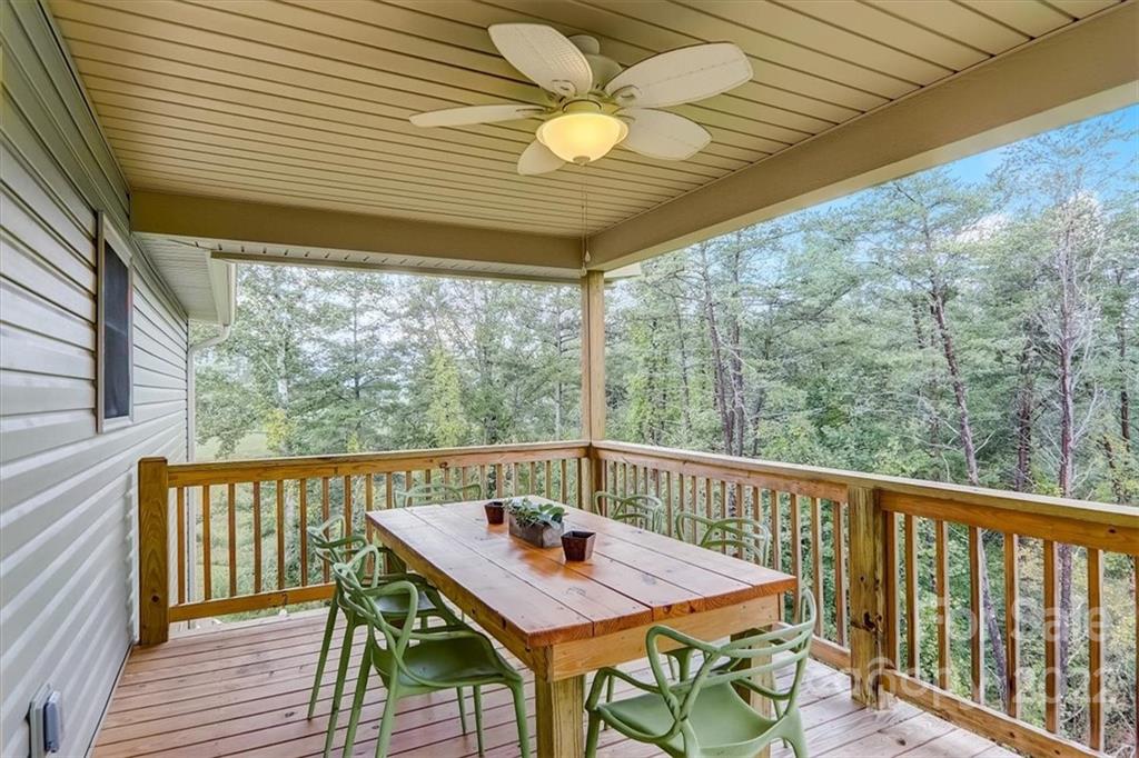 11 Ridge Brook Drive Weaverville, NC 28787 - Photo 29 of 38 a view of a balcony with chairs and wooden floor