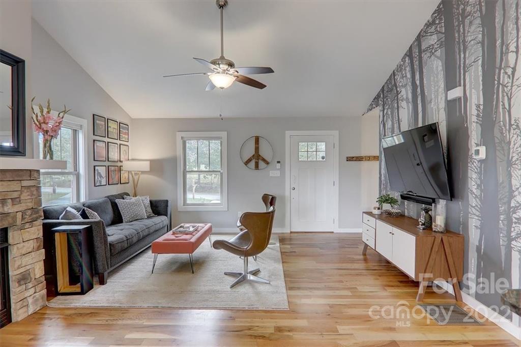 11 Ridge Brook Drive Weaverville, NC 28787 - Photo 6 of 38 a living room with furniture a flat screen tv and a window