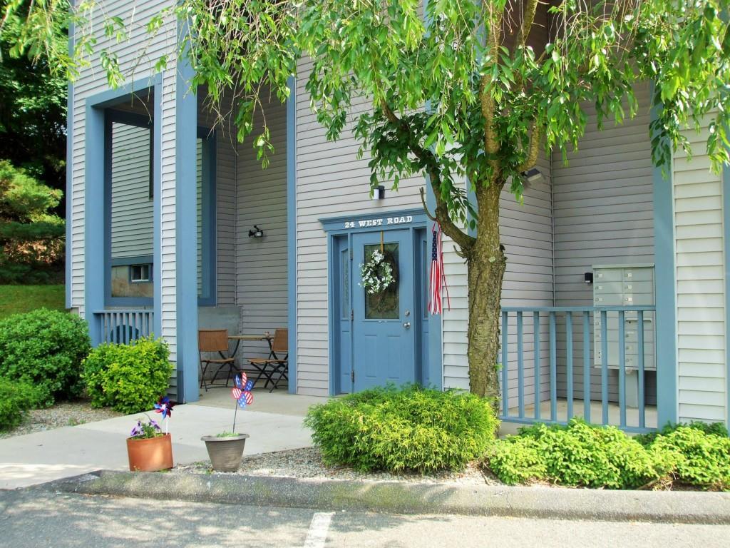 24 West Road, Unit 28 Ellington, CT 06029 - Photo 1 of 1 a view of a house with potted plants and a tree