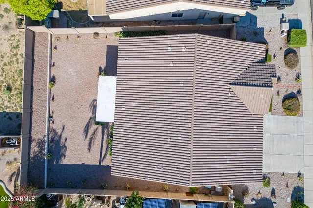 a view of a house with a yard and potted plants