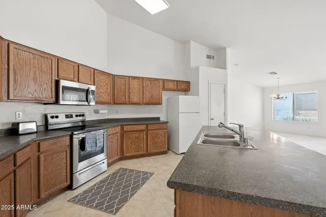 a kitchen with stainless steel appliances granite countertop a stove and a refrigerator