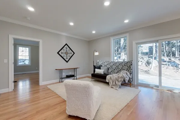 a bedroom with furniture and a large window