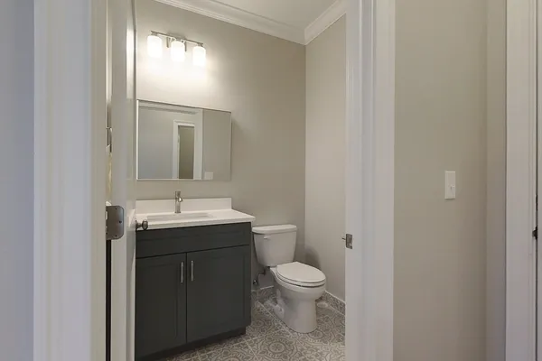 a bathroom with a toilet sink and mirror