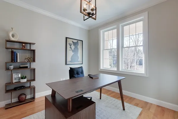 a view of a workspace with furniture and a window