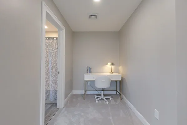 a view of a bathroom with a sink and a mirror