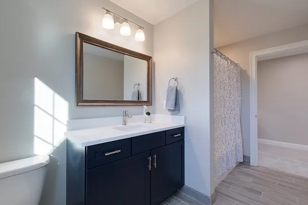 a bathroom with a double vanity sink and a mirror