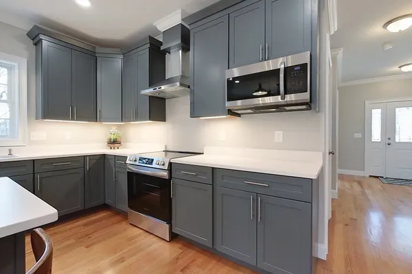 a kitchen with stainless steel appliances granite countertop a sink and stove top oven