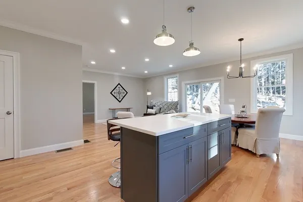 a kitchen with kitchen island a sink stove and wooden floor