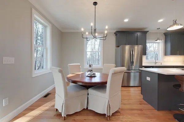 a dining room with furniture a window and kitchen view
