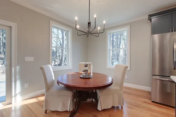 a view of a dining room with furniture window and wooden floor