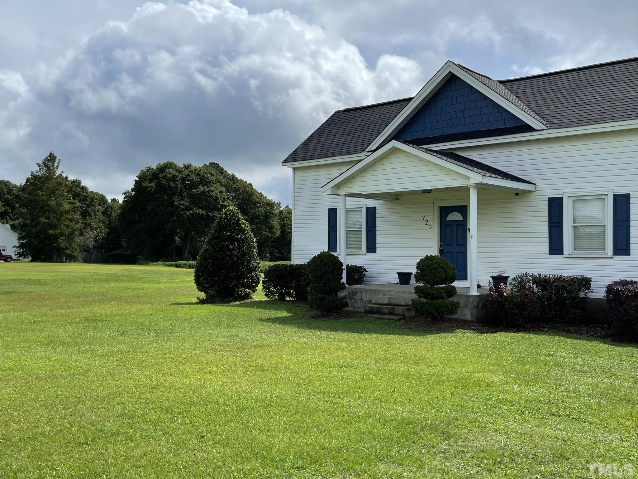 720 Mitchell Road Angier, NC 27501 - Photo 2 of 25 a house view with a garden space