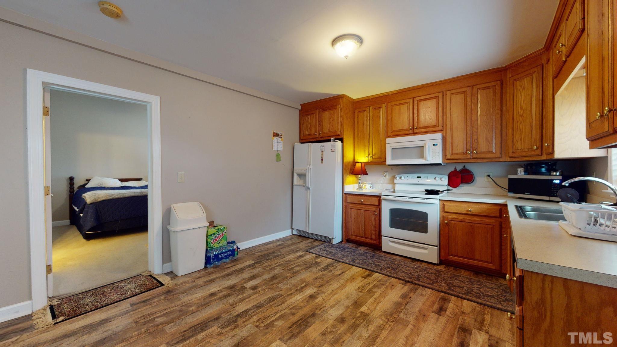 720 Mitchell Road Angier, NC 27501 - Photo 13 of 25 a kitchen with a sink cabinets and appliances