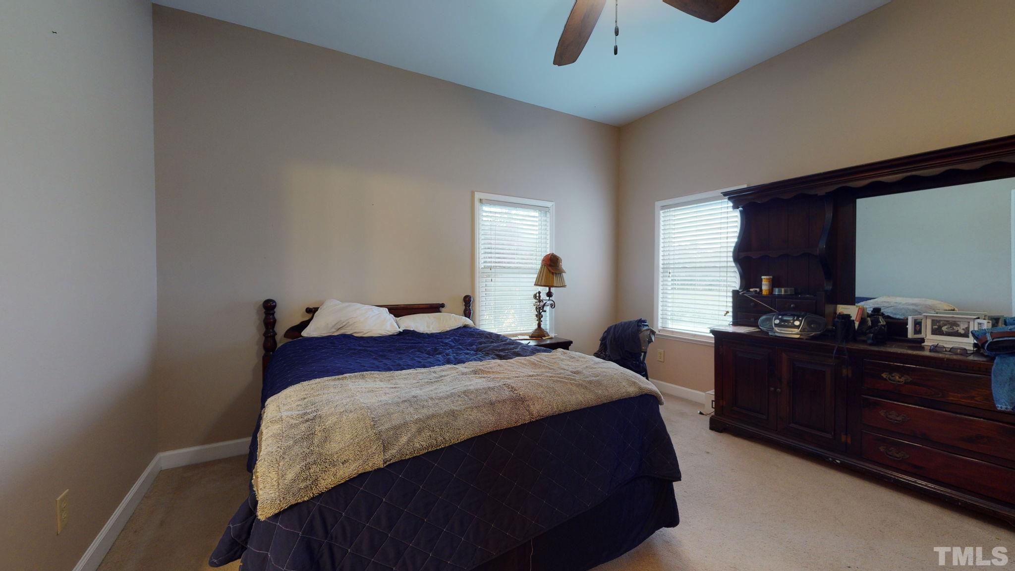 720 Mitchell Road Angier, NC 27501 - Photo 14 of 25 a bedroom with a bed and a dresser