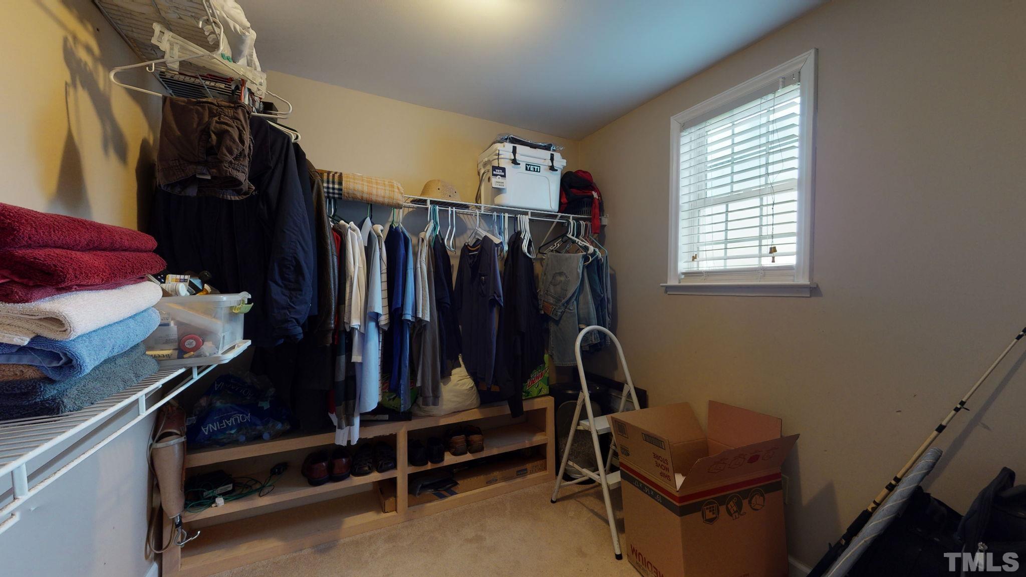 720 Mitchell Road Angier, NC 27501 - Photo 16 of 25 a view of walk in closet with clothes and shoes