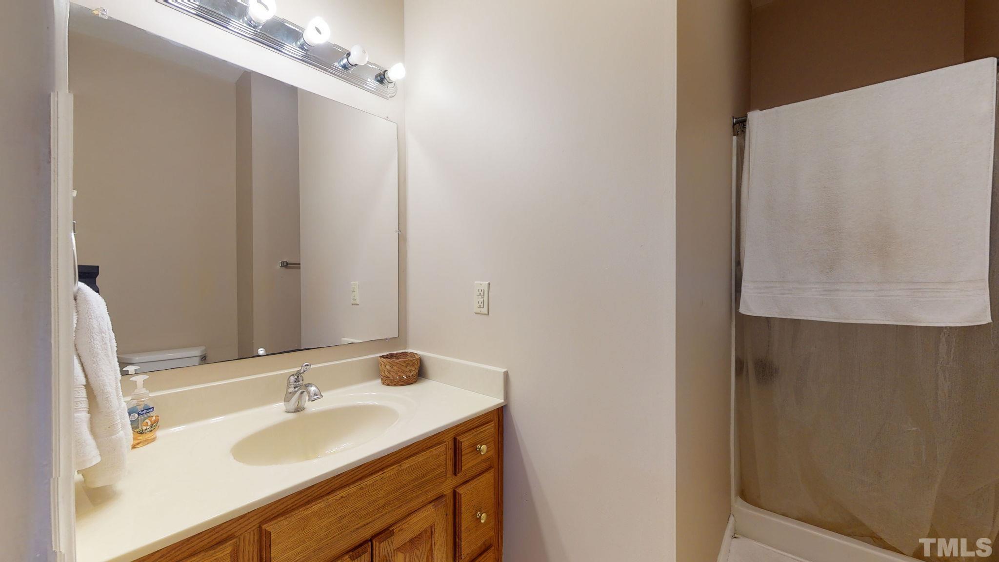 720 Mitchell Road Angier, NC 27501 - Photo 17 of 25 a bathroom with a sink and a mirror