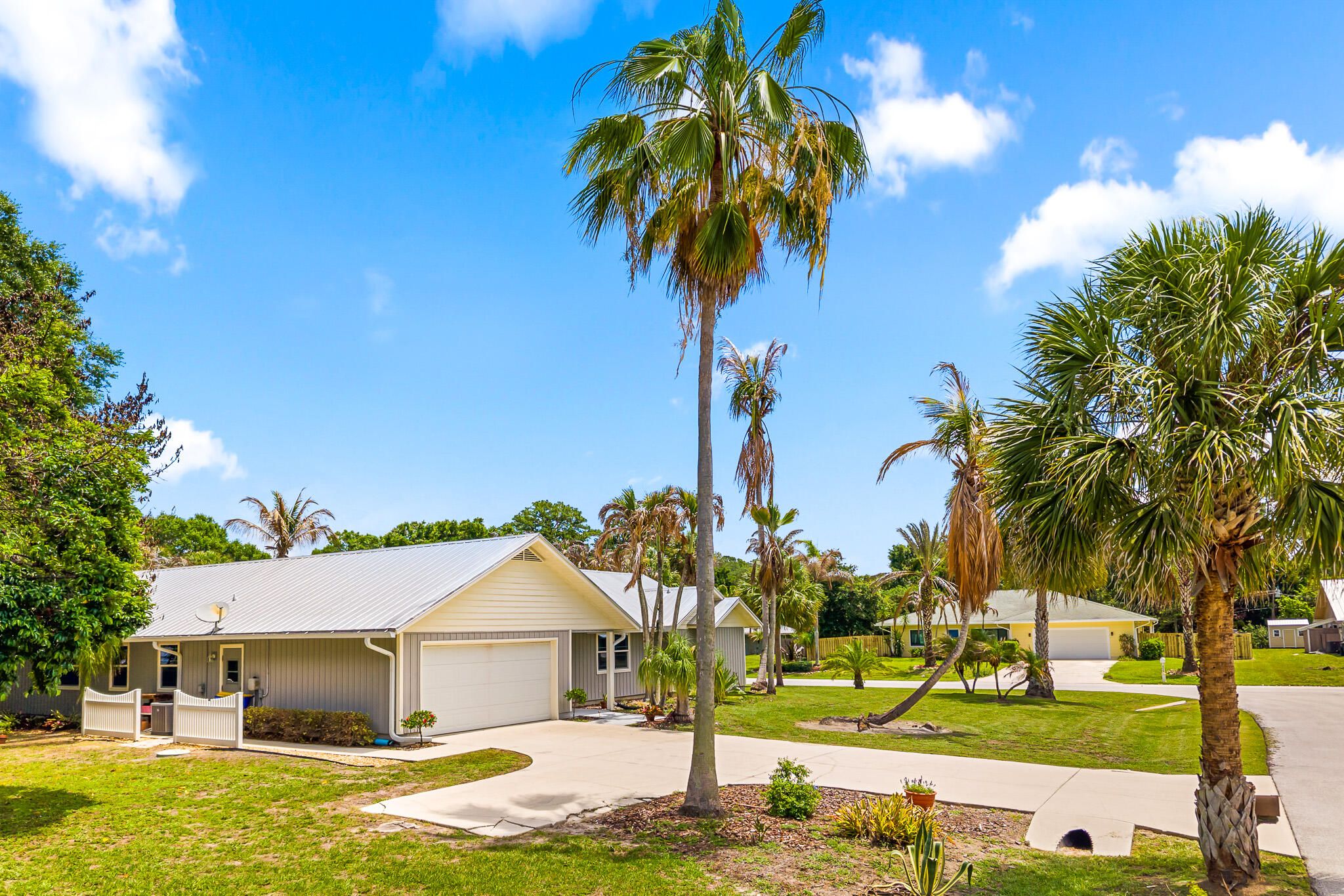 1653 Southwest 85th Terrace Stuart, FL 34997 - Photo 3 of 54 a front view of a house with garden